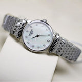 Silver wristwatch with white face and diamond markers.
