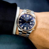 Wrist watch with blue face and gold accents.