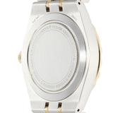 Back of a silver and gold wristwatch.
