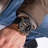 Guess watch on wrist - black and gold chronograph