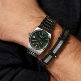 Tissot PRX watch with green dial and bracelet on wrist