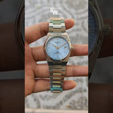 Tissot PRX watch held by hand, hq720